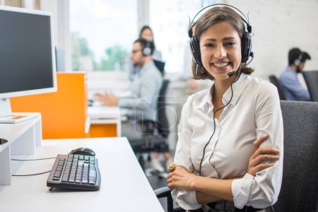 Photo for Portrait of smiling young woman operator in headset at office. - Royalty Free Image