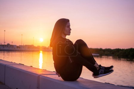 Téléchargez les photos : Young fit woman doing butt balance exercise outdoors - en image libre de droit