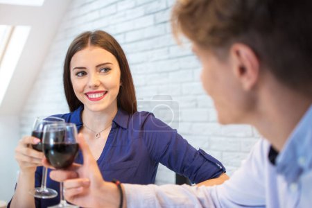 Photo for Happy couple romantic date drink glass of red wine at home - Royalty Free Image
