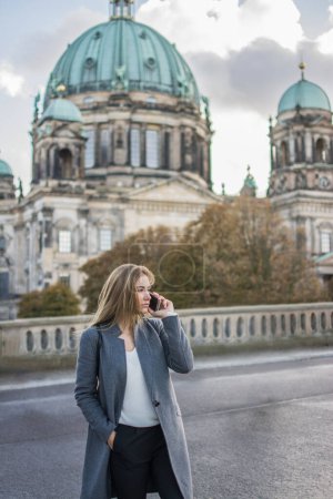 Photo for Young business woman talking on the phone, Berlin, Germany. - Royalty Free Image