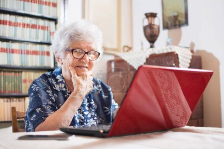 Photo for Surprised senior woman looking at laptop - Royalty Free Image