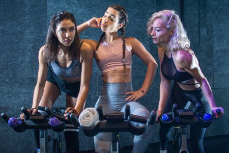 Photo for Group of young sporty women having fun after cycling training at gym. - Royalty Free Image
