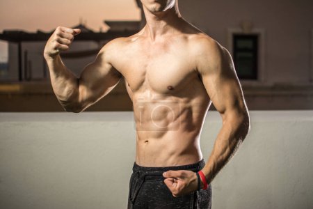 Photo for Fit handosome mans body with strong arms and six pack. - Royalty Free Image