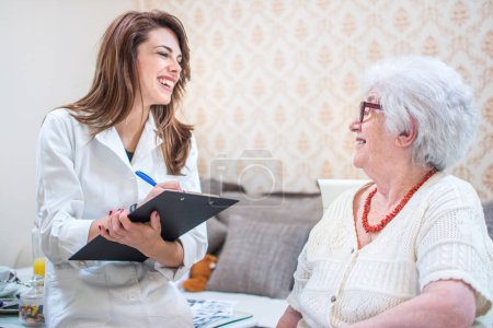 Home healthcare nurse talking to senior patient