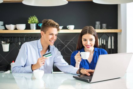 Foto de Compras en línea. Feliz pareja sonriente usando tarjeta de crédito para comprar en línea en casa - Imagen libre de derechos