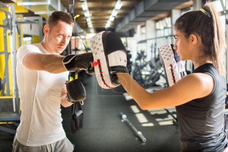 Photo for Young couple practicing boxing together in gym - Royalty Free Image