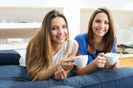Photo for Twins having coffee time at home - Royalty Free Image