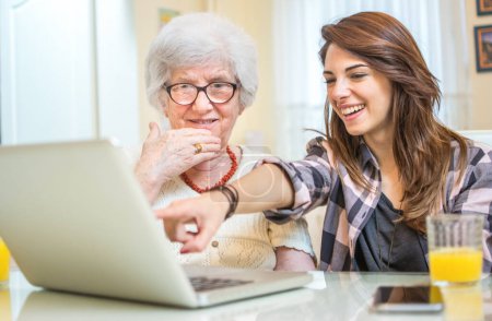 Photo for Granddaughter showing her grandmother something on laptop - Royalty Free Image