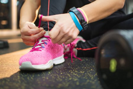 Photo for Female hands tying sport shoes laces before training. - Royalty Free Image