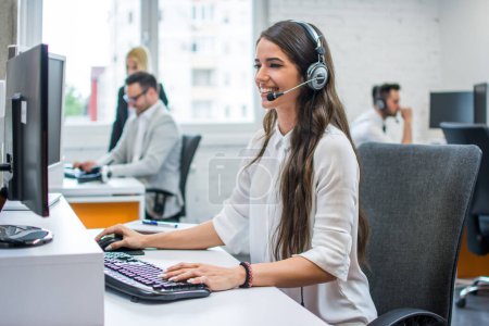 Photo for Portrait of young attractive happy smiling female customer support phone operator at modern office - Royalty Free Image