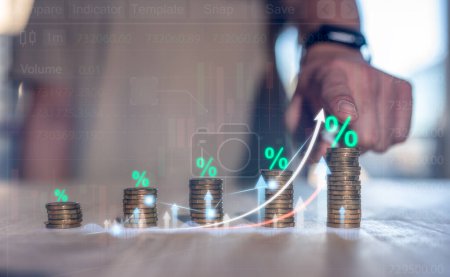 investment return on asset concept, interest rate increase percent, finance interest back rate increase , saving, deposit, businessman pointing at stacking of coins with percent symbol