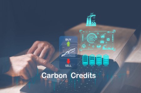 Photo for Trader using computer laptop to trade carbon credit on application. Net zero emission, Clean technology, Renewable energy concept, carbon ETF to invest in sustainable business. green climate funds - Royalty Free Image