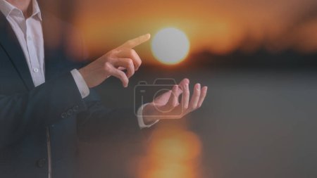 Photo for Hope concept multi exposure businessman hold and poiting to the sun in golden hours - Royalty Free Image