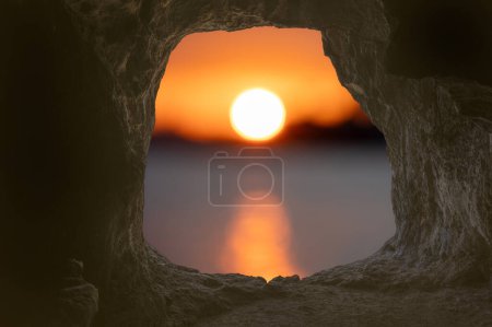 view from cave hole exit from the cave, sunrise or sunset scene view in concept of hope and belief