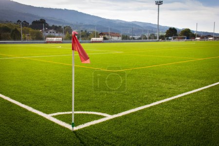 Photo for Red flag on corner kick in green artificial grass soccer field. Football World Cup concept - Royalty Free Image
