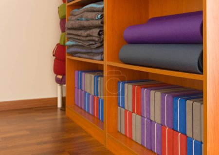 Photo for Yoga supplies on wooden shelves - Royalty Free Image
