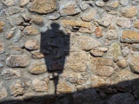 shadow of a street lamp on the stone wall