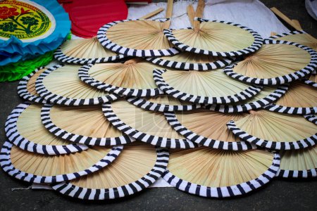 Photo for Artistic Hand Fan, Pakha, Air Blower or Bamboo Made Handicraft Fan with Handle Sold in Pahela Baishakh - Bangla New Year - Royalty Free Image