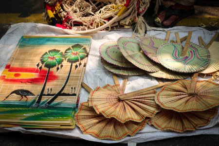 Photo for Hand Fan, Pakha, Pankha, Air Blower or Bamboo Made Handicraft Fan with Handle Sold in Pahela Baishakh - Bangla New Year - Royalty Free Image