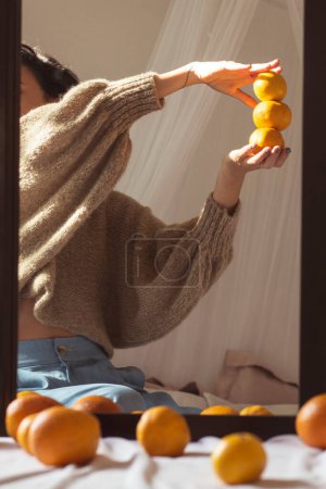 Photo for Hand holding oranges at sun light - Royalty Free Image