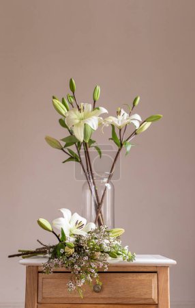 Photo for Lilies in a vase on the table - Royalty Free Image
