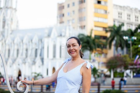 Photo for Beautiful tourist woman at the Ortiz Bridge with La Ermita church on background in the city of Cali in Colombia - Royalty Free Image
