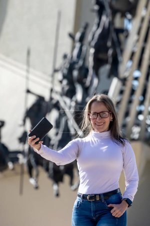 Téléchargez les photos : Une touriste prend des selfies au mémorial des Lanceurs du Marais Vargas situé près de la ville de Paipa à Boyaca. Réalisé par l'artiste colombien Rodrigo Arenas Betancourt et l'ingénieur Guillermo Gonzalez Zuleta. - en image libre de droit