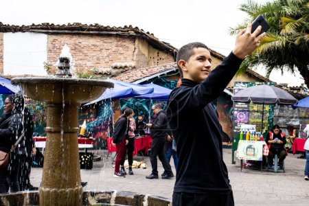 Photo for BOGOTA, COLOMBIA - MAY 22nd 2023. Young tourist taking selfies at the famous Chorro de Quevedo in Bogota city center. - Royalty Free Image