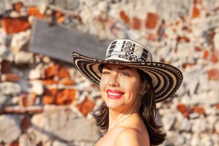 Beautiful woman wearing the traditional Colombian hat called Sombrero Vueltiao at San Ignacio Bulwark in the historical Cartagena de Indias walled city