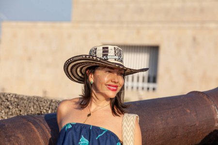 Beautiful woman wearing the traditional Colombian hat called Sombrero Vueltiao at San Ignacio Bulwark in the historical Cartagena de Indias walled city