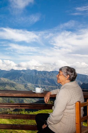 Senior woman tourist looking at the amazing landscapes of the Central Ranges on the ascent to the High of Letters between the cities of Fresno and Manizales in Colombia