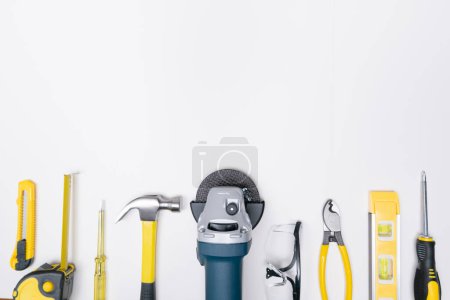Foto de Top view selective focus grinder and construction DIY tools on white background. - Imagen libre de derechos