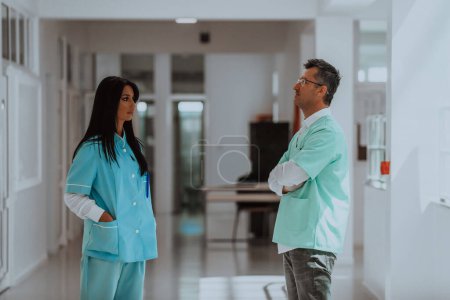 Photo for A doctor in a discussion with a nurse about medical problems and patient care in a modern hospital, highlighting their collaborative approach, expertise, and dedication to finding effective solutions - Royalty Free Image