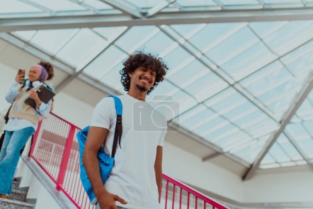 Foto de Estudiante afroamericano con una mochila azul, luciendo un moderno peinado afro y una amplia sonrisa, irradia entusiasmo y representa el espíritu vibrante de una universidad moderna, encarnando la ambición - Imagen libre de derechos