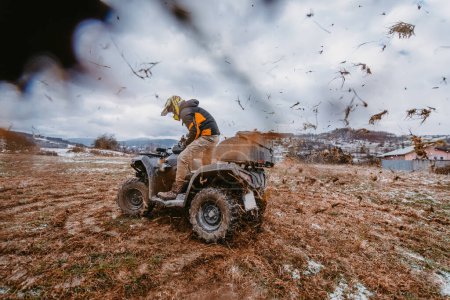 Photo for A man is fearlessly enjoying an adventurous ride on an ATV Quad through hazardous snowy terrain, embracing the thrill and excitement of the challenging mountainous landscape. - Royalty Free Image