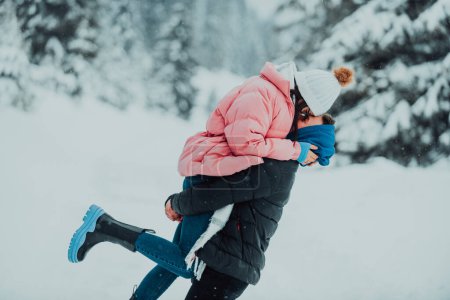 Photo for On a snowy Valentines Day, this romantic couple shares warmth, laughter, and tender embraces, creating a blissful winter love story - Royalty Free Image