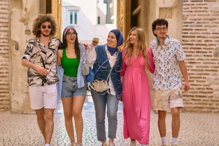 A diverse group of tourists, dressed in summer attire, strolls through the tourist city with wide smiles, enjoying their sightseeing adventure. 