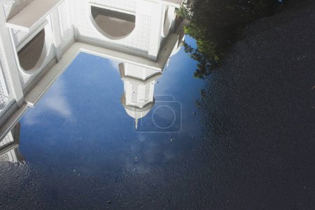 Photo for View of the White Mosque with water reflections on the road against a blue sky background - Royalty Free Image