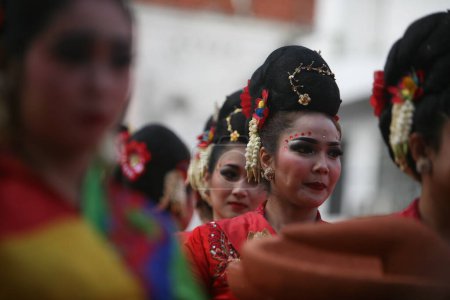 Photo for Surabaya residents participate in the celebration of the rujak ulek festival by wearing traditional clothes and costumes - Royalty Free Image