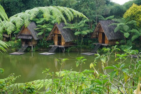 Photo for Bandung, Indonesia - February, 2023 : Panorama of a lake surrounded by wooden houses with boats in Bamboo Village (Dusun Bambu) at Lembang, Bandung, Indonesia. - Royalty Free Image