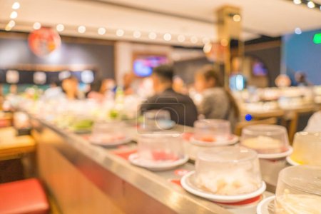 Photo for Blurred background Interior of cozy restaurant. Contemporary design in loft style, modern dining place and bar counter, copy space. Hot pot conveyor. - Royalty Free Image