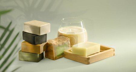 Natural organic soap bars. Homemade Soap Stack on green background. Soap made according to ancient recipes in Syria Aleppo Using oils of laurel olive and others