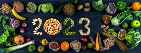 Cereals, vegetables, fruits, organic arranged around 2023 in seeds.
