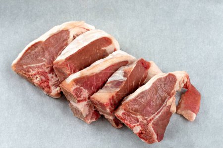 Photo for Lamb ribs lined up, top view, close-up, on wrapping, paper. - Royalty Free Image