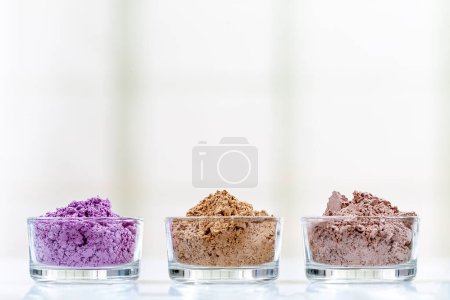 Photo for 3 powdered clays aligned horizontally on a light background. - Royalty Free Image