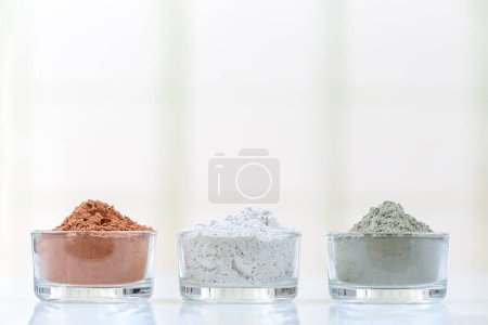 Photo for 3 powdered clays aligned horizontally on a light background. - Royalty Free Image