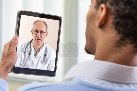 Photo for Man calls the doctor online. Telemedicine concept. Future broadcast consultation. Diagnosis from home. - Royalty Free Image