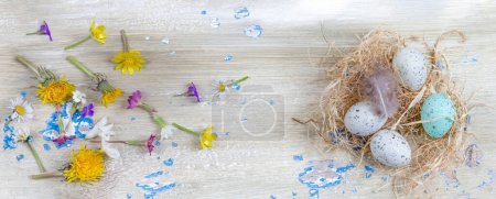 Photo for Flowers on the left and eggs on the right, view from above-Light background. - Royalty Free Image