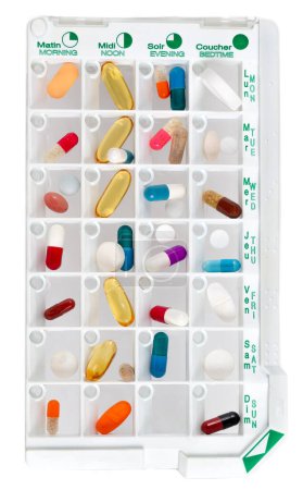 Téléchargez les photos : Daily pill box with medications and nutritional supplements. Closeup.white background. - en image libre de droit