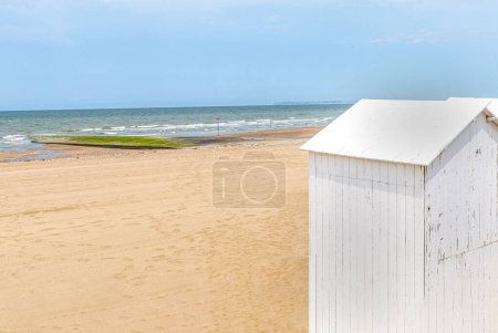 Photo for Traditional white wooden beach cabins on the beach of Villers, Normandy, France - Royalty Free Image